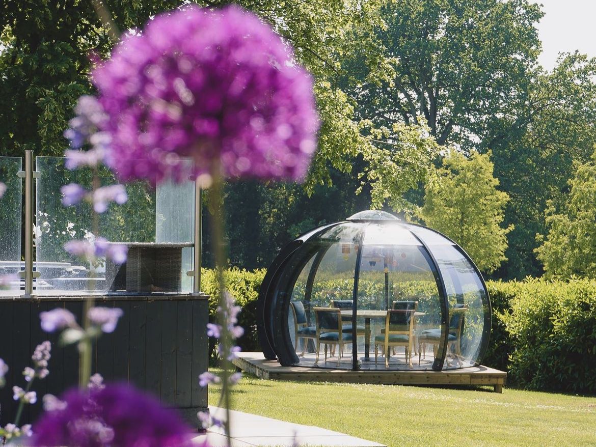 Garden dining dome with summer flowers 