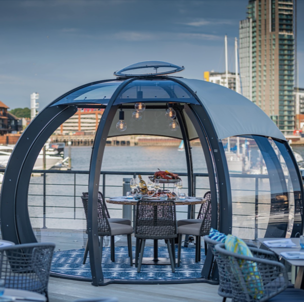 Beautifully decorated dining pod overlooking Southampton harbour on a hotel terrace