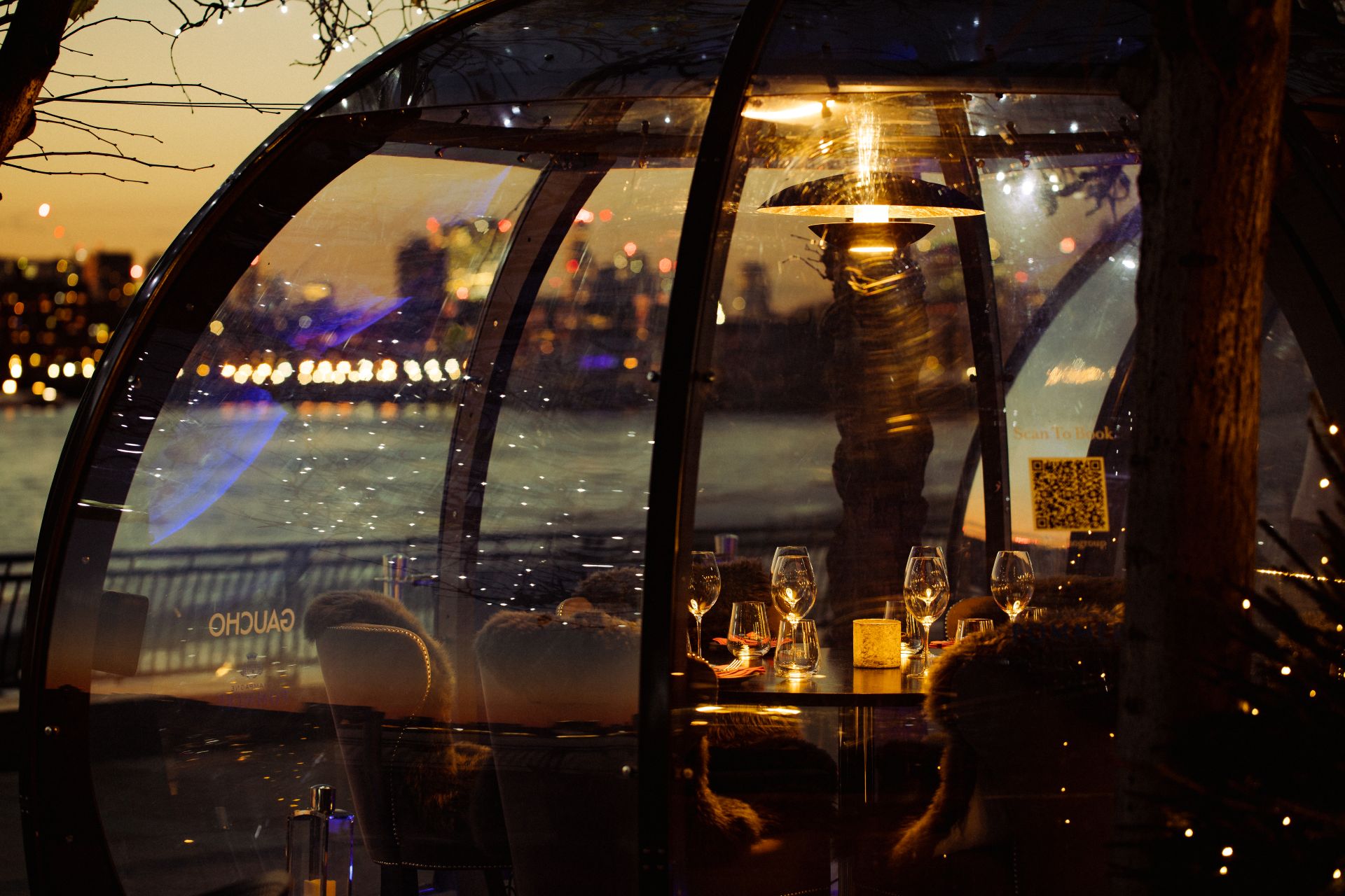 Gaucho Canary Wharf dining dome overlooking the river in London at night 