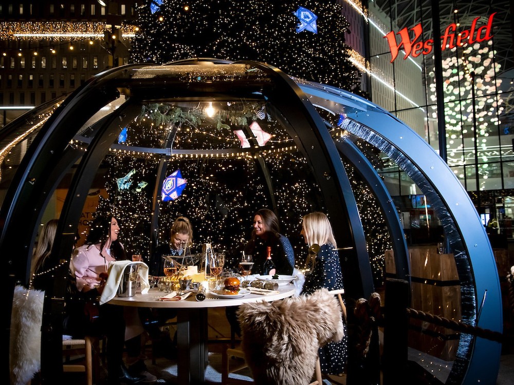 Friends inside the Christmas igloos at Westfield Shopping Centre 