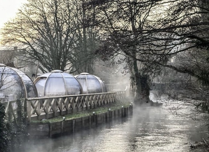 Winter igloos next to a beautiful river 
