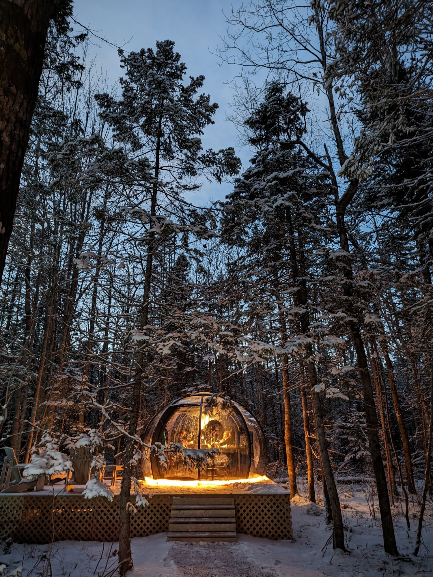 Dining dome on a raised wooden terrace in snowy Canada