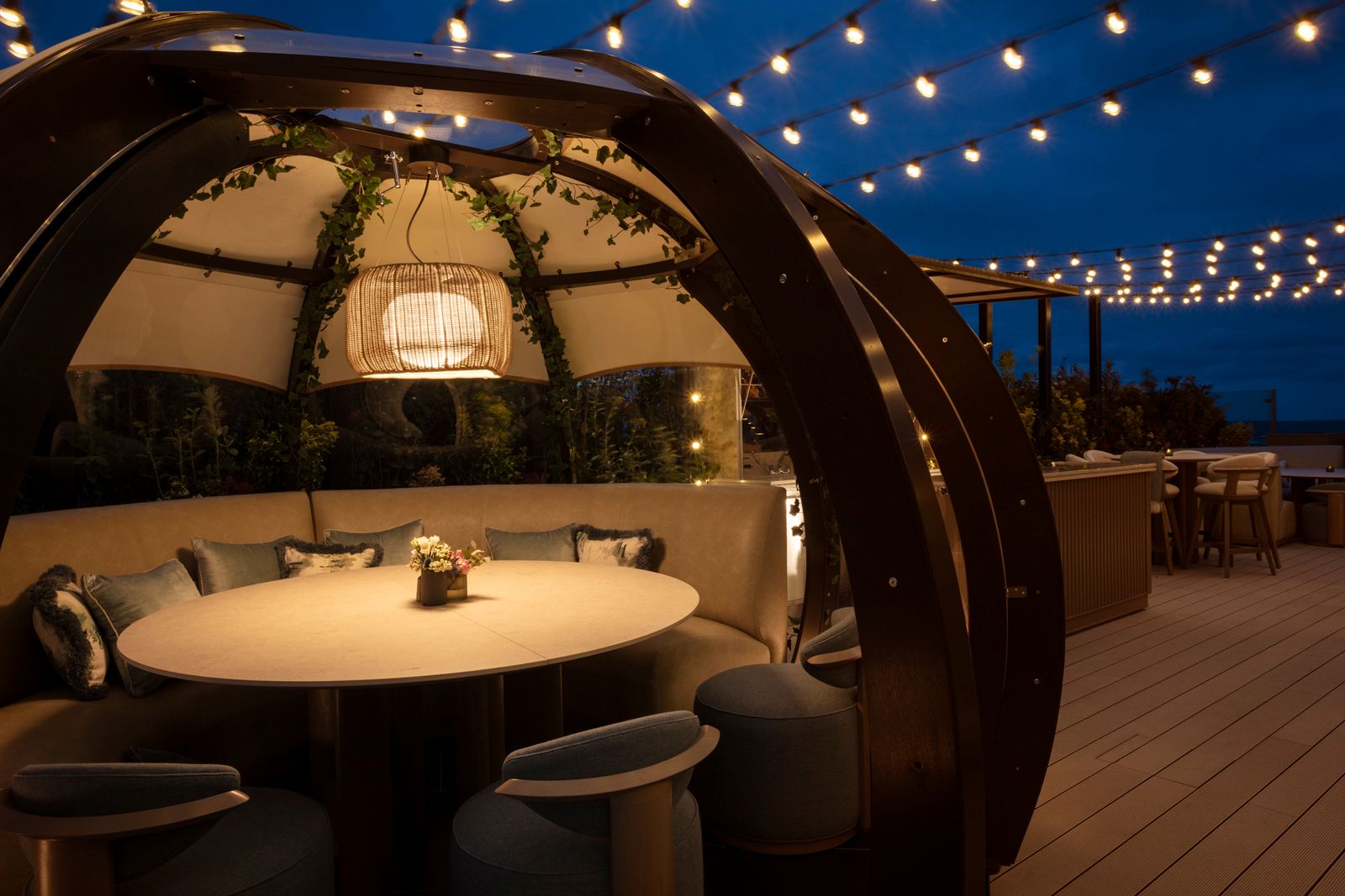 Interior decor of a dining pod at old course hotel in Scotland with banquette seating and gorgeous lighting 