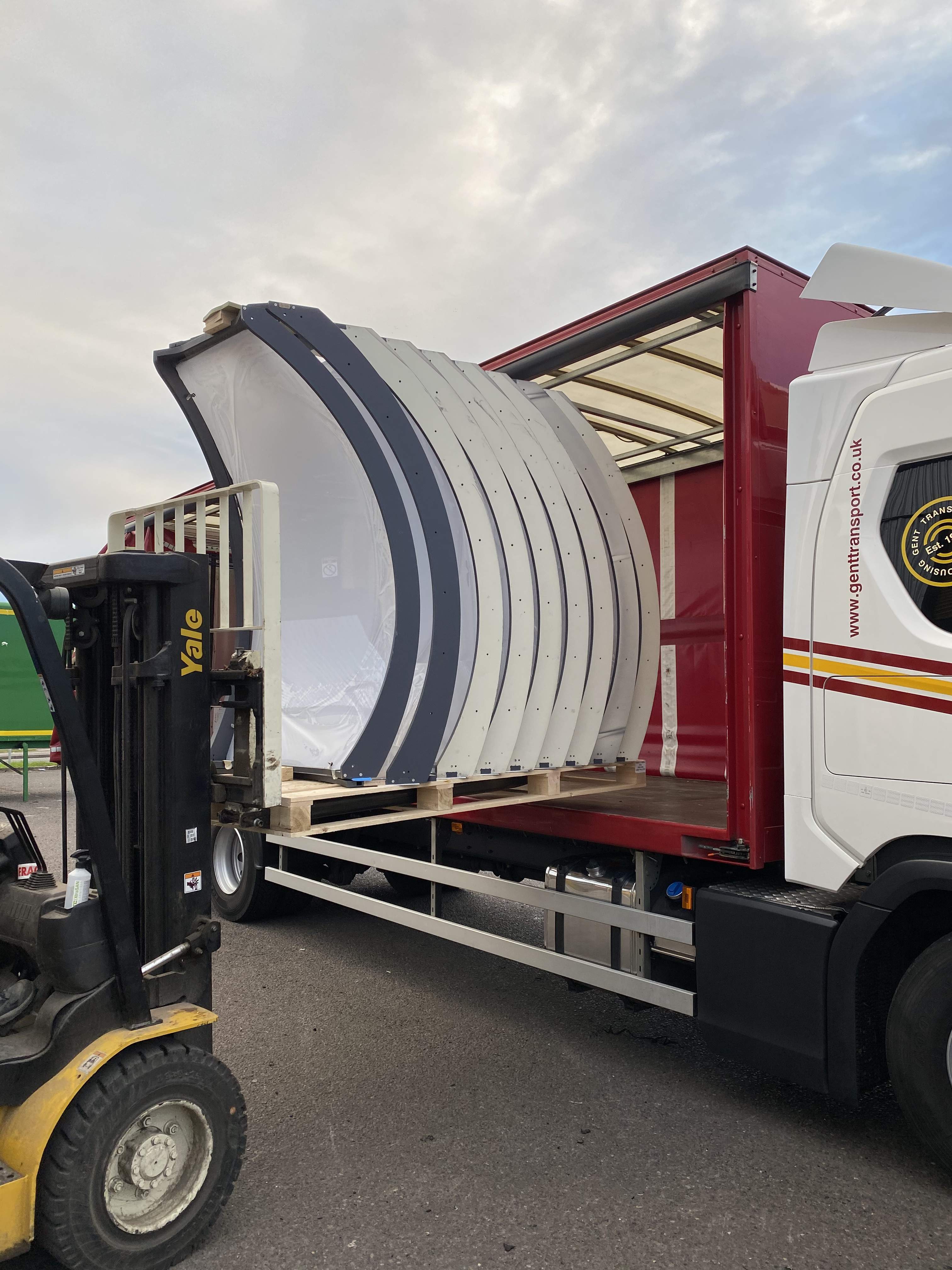 Modular dining pod segments being loaded onto a lorry by forklift ready to be delivered 