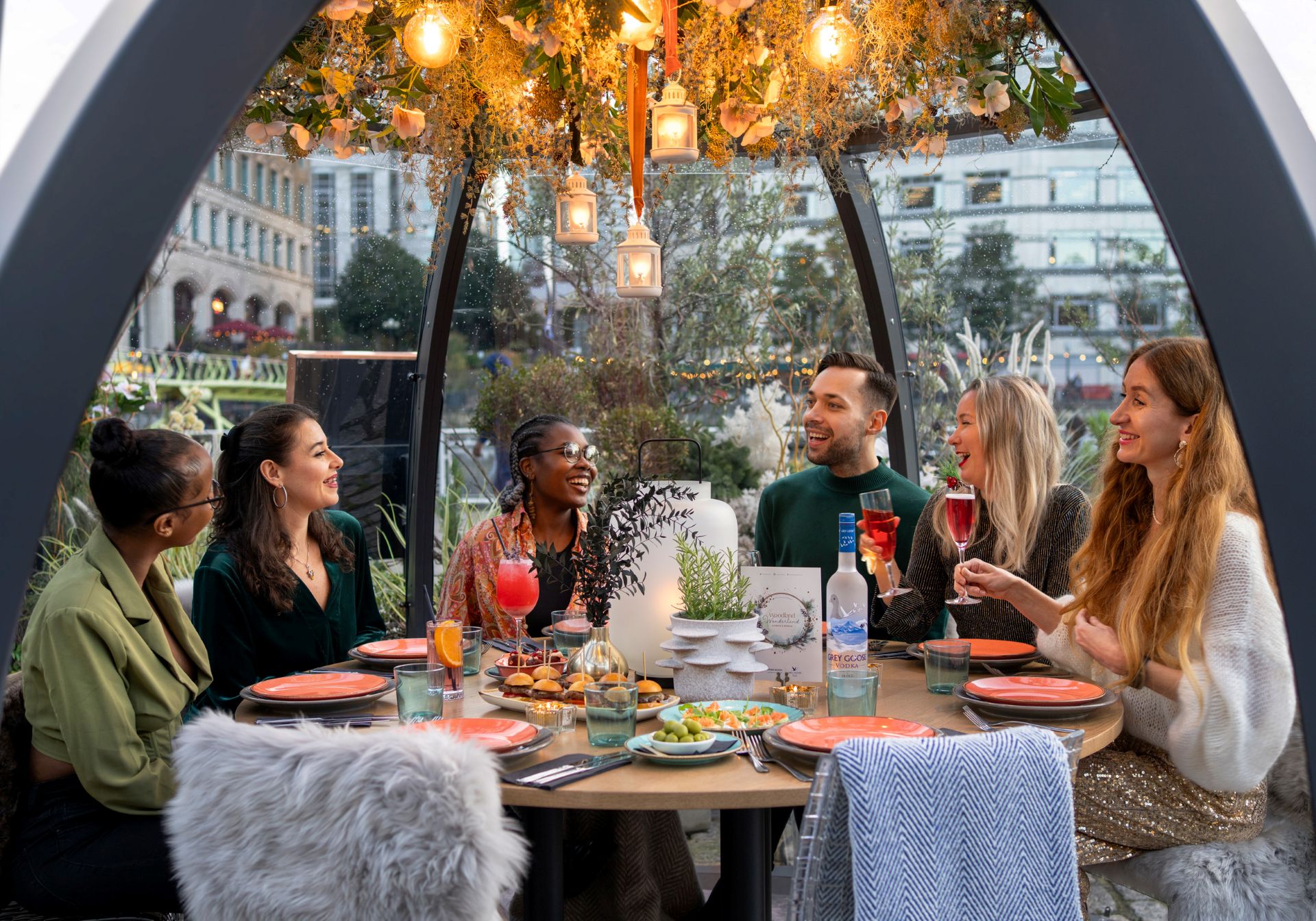 Friends enjoying a private dining experience in a pod at The Sipping Room 